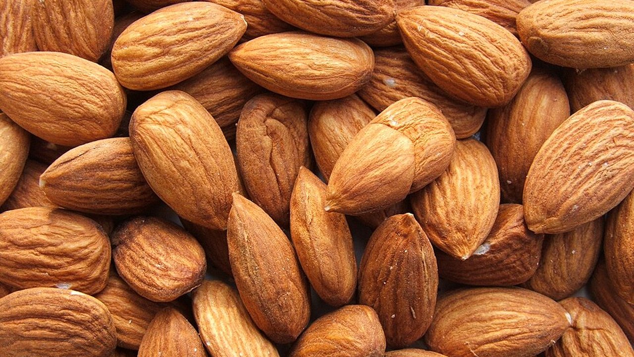 A pile of whole raw almonds