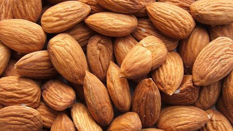 A pile of whole raw almonds