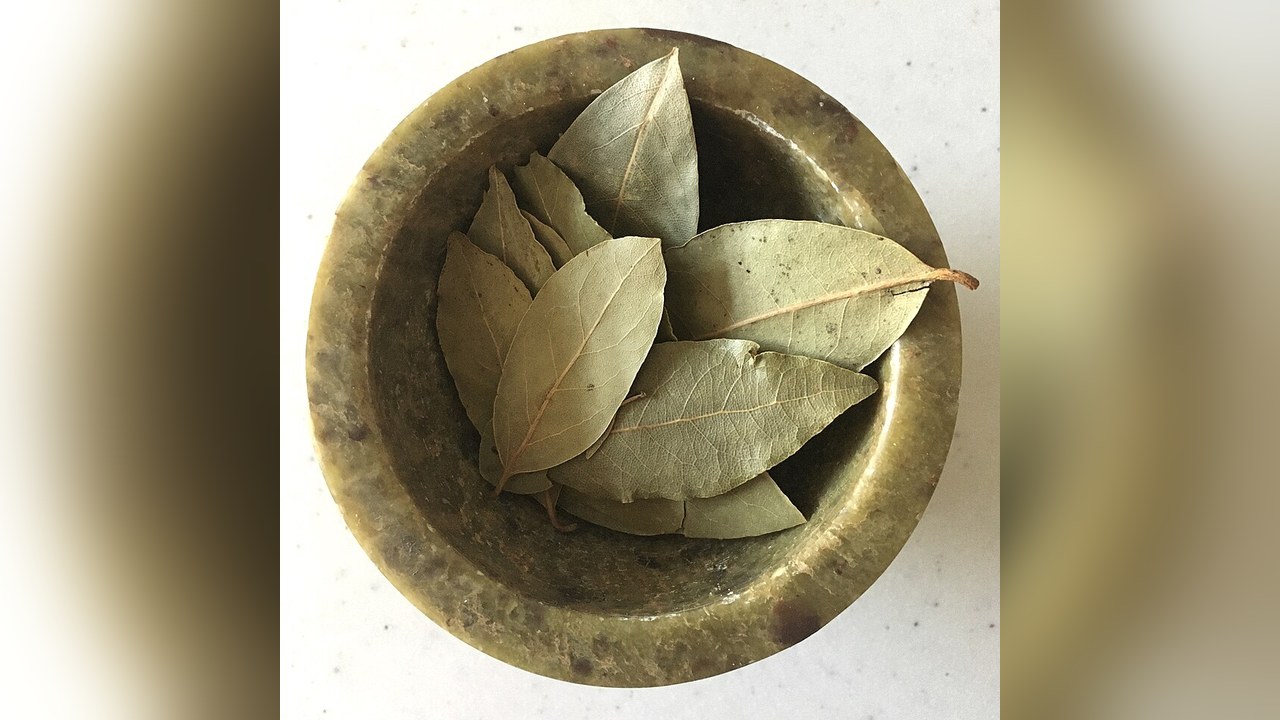 Dried bay leaves in a small brass bowl