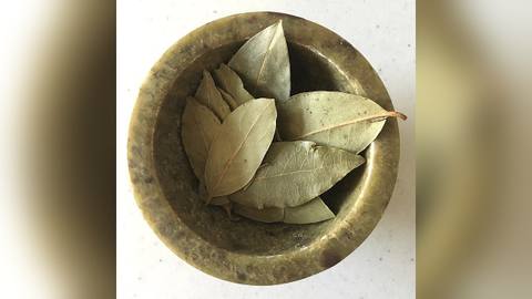Dried bay leaves in a small brass bowl