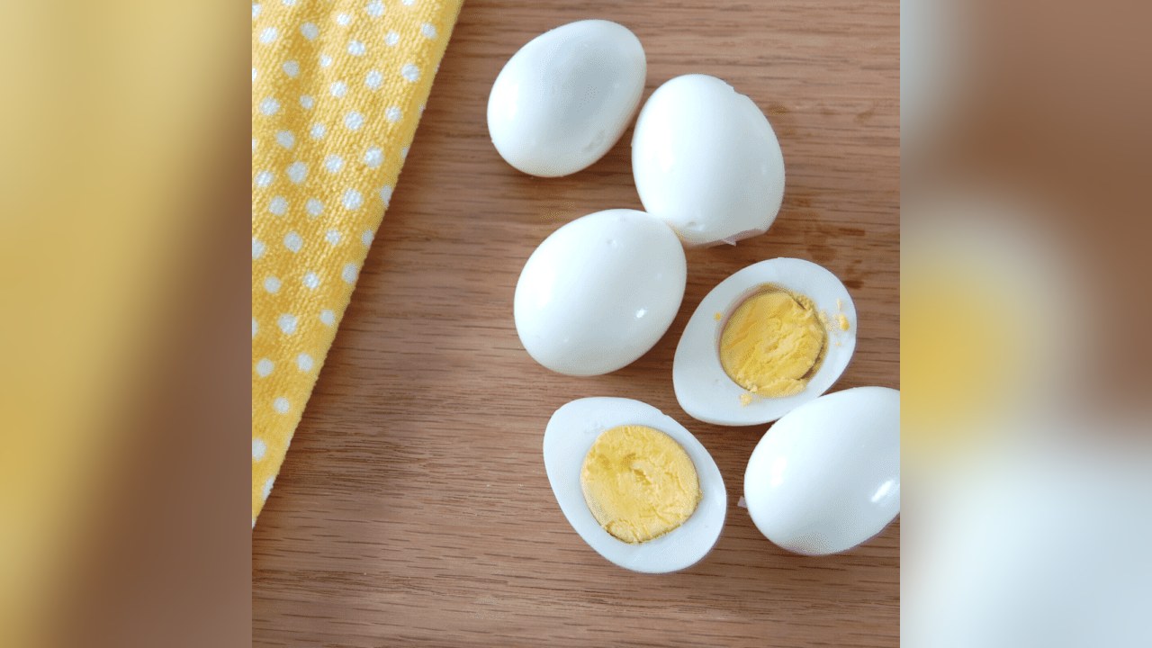 Peeled hard-boiled eggs, some halved to show the yolk