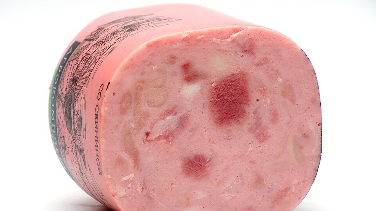 A rounded slab of pink ham with the cut side showing