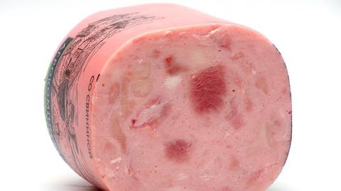 A rounded slab of pink ham with the cut side showing