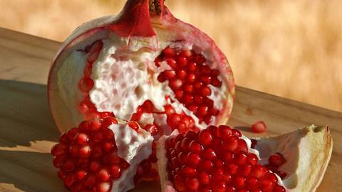 A split-open pomegranate showing the red seeds