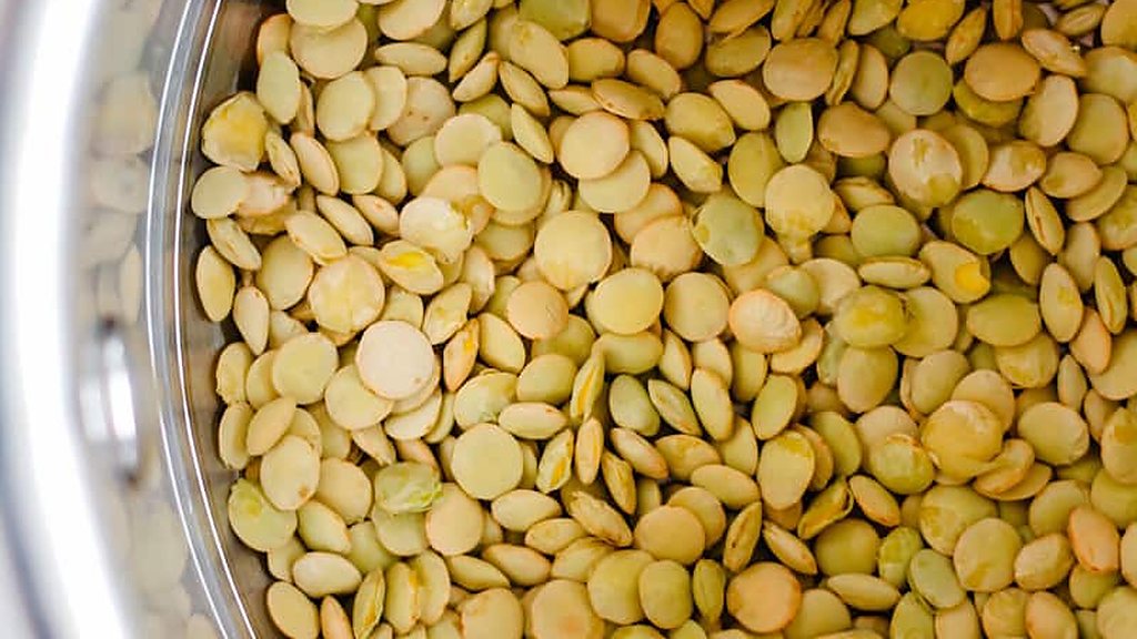 Dry green lentils in a stainless steel pot