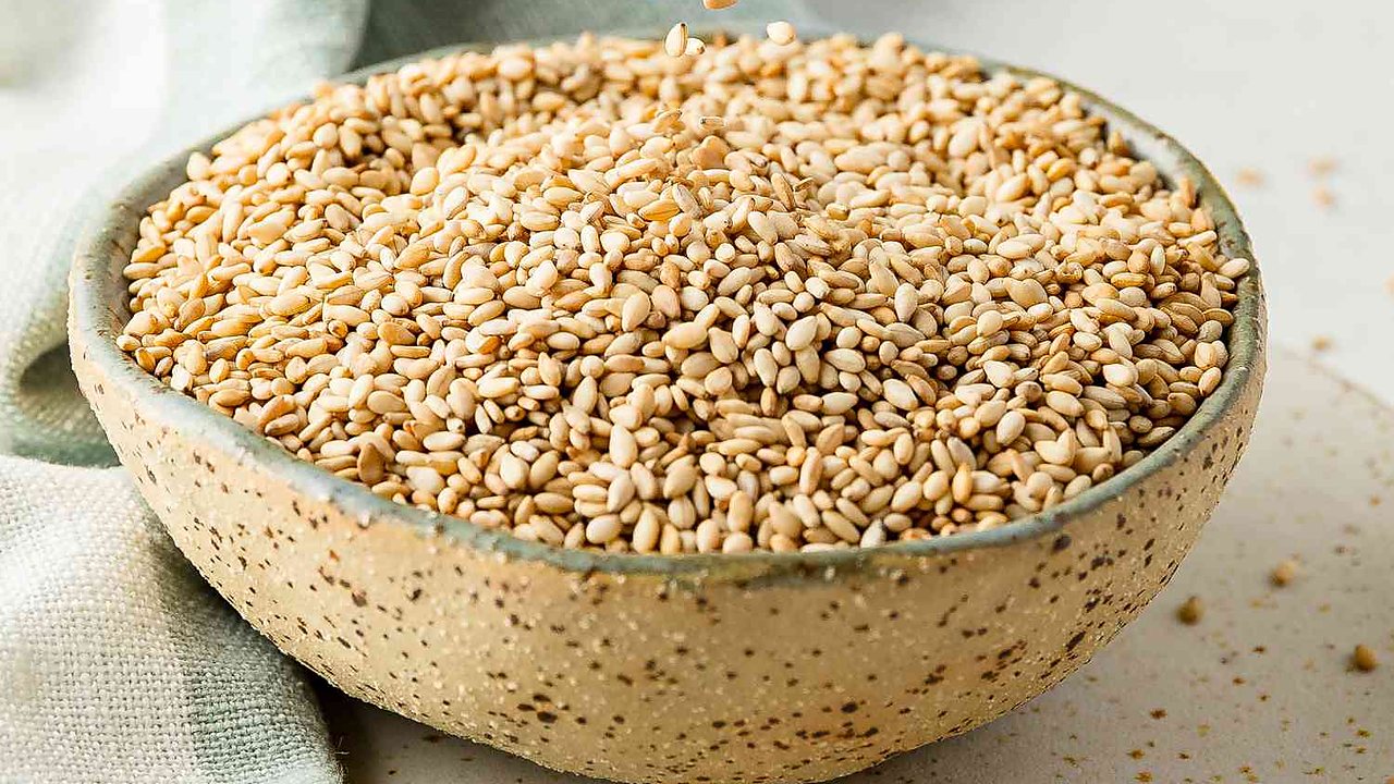 A ceramic bowl full of sesame seeds